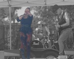 Band on stage with lead singer highlighted