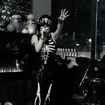 Black and white photo of Rock and roll singer dressed up for halloween in skeleton costume.