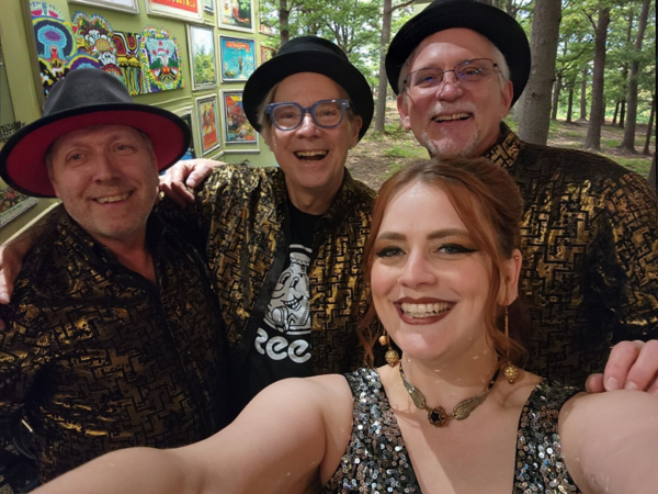 one woman and three men in gold holiday themed shirts